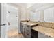 Bathroom featuring a granite countertop vanity and a doorway to a tiled shower-tub combination at 534 N Ingleside Farm Rd, Iron Station, NC 28080