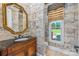 Elegant bathroom with ornate mirror, wood vanity, and a bright window view at 534 N Ingleside Farm Rd, Iron Station, NC 28080