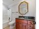 Bathroom features a shower-tub combination and a decorative gold-trimmed octagonal mirror above the vanity at 534 N Ingleside Farm Rd, Iron Station, NC 28080
