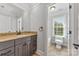 This bathroom includes tile flooring, a window over the bathtub, and a vanity with granite countertops at 534 N Ingleside Farm Rd, Iron Station, NC 28080