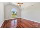 Bedroom with high ceilings, hardwood floors, and an arched window with a view at 534 N Ingleside Farm Rd, Iron Station, NC 28080