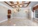 Formal dining room featuring custom ceiling, chandelier, travertine floors, and decorative wall sconces at 534 N Ingleside Farm Rd, Iron Station, NC 28080
