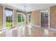 Dining room with chandelier, travertine floors, and access to the backyard at 534 N Ingleside Farm Rd, Iron Station, NC 28080