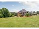 Spacious two-story brick home with a manicured lawn and mature trees in a serene, park-like setting at 534 N Ingleside Farm Rd, Iron Station, NC 28080