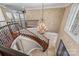 Grand foyer with a winding staircase, detailed iron railings, and chandelier at 534 N Ingleside Farm Rd, Iron Station, NC 28080