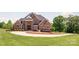 Elegant two-story brick home with a circular driveway, lush lawn, and manicured landscaping at 534 N Ingleside Farm Rd, Iron Station, NC 28080