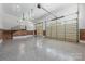 Spacious garage with epoxy flooring, ample lighting, and access to the upper level at 534 N Ingleside Farm Rd, Iron Station, NC 28080