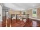 Upstairs hallway featuring hardwood floors, elegant iron railings, and chandelier at 534 N Ingleside Farm Rd, Iron Station, NC 28080