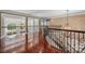 Spacious upstairs hallway with hardwood floors, columns and iron railings at 534 N Ingleside Farm Rd, Iron Station, NC 28080