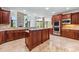 Gourmet kitchen with custom cabinets, granite countertops, stainless steel appliances, and stone accent wall at 534 N Ingleside Farm Rd, Iron Station, NC 28080