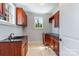 Laundry room with utility sink, granite countertops, and window to the outside at 534 N Ingleside Farm Rd, Iron Station, NC 28080