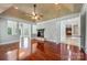 Open living room features hardwood floors, tray ceilings, fireplace, and views to the backyard at 534 N Ingleside Farm Rd, Iron Station, NC 28080