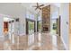 Open living room with tall ceilings, large windows, stone fireplace and travertine floors at 534 N Ingleside Farm Rd, Iron Station, NC 28080