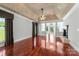 Spacious living room with fireplace, tray ceilings, hardwood floors and large picture windows at 534 N Ingleside Farm Rd, Iron Station, NC 28080