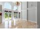 Spacious living room with high ceilings, French doors, and travertine floors at 534 N Ingleside Farm Rd, Iron Station, NC 28080