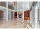 Large living room with fireplace, built-in bookshelves, travertine floors, and natural light at 534 N Ingleside Farm Rd, Iron Station, NC 28080