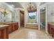 Luxurious bathroom with a walk-in shower, soaking tub, dual vanities, and chandelier at 534 N Ingleside Farm Rd, Iron Station, NC 28080