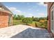 Outdoor patio featuring tile flooring and views of the manicured backyard at 534 N Ingleside Farm Rd, Iron Station, NC 28080