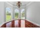 Bright sitting area with hardwood floors, chandelier, and lots of natural light from large windows at 534 N Ingleside Farm Rd, Iron Station, NC 28080