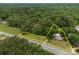 Aerial view of the property lines surrounded by lush greenery and a road at 5371 Davidson Rd, Davidson, NC 28036