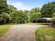 A gravel parking area and a metal carport are located in the backyard at 5371 Davidson Rd, Davidson, NC 28036