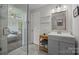 Chic bathroom featuring a glass shower, stylish vanity, and a glimpse into the connecting bedroom at 5371 Davidson Rd, Davidson, NC 28036