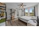 Comfortable bedroom boasts natural light, barn door to bathroom, and stylish shelving for books at 5371 Davidson Rd, Davidson, NC 28036