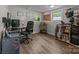 A finished bonus room features a hardwood floor, two windows, and golf equipment at 5371 Davidson Rd, Davidson, NC 28036
