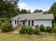 Charming single-story home with a covered front porch, well-maintained lawn, and mature landscaping at 5371 Davidson Rd, Davidson, NC 28036