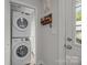 Efficient laundry area features a stacked washer and dryer for space-saving convenience and organization at 5371 Davidson Rd, Davidson, NC 28036