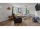 Bright living room featuring wood floors, neutral walls, a ceiling fan, and comfortable seating at 5371 Davidson Rd, Davidson, NC 28036