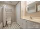 Bathroom with a tiled floor, tub, and a white cabinet vanity with a large framed mirror at 5604 Bethesda Ct, Charlotte, NC 28226