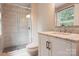 Modern bathroom featuring a glass shower, neutral tile, and marble vanity at 5604 Bethesda Ct, Charlotte, NC 28226