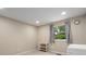 Neutral bedroom with natural light, storage shelves, and neutral window coverings at 5604 Bethesda Ct, Charlotte, NC 28226