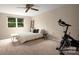Bedroom with bright window and neutral walls; exercise bike and furniture included at 5604 Bethesda Ct, Charlotte, NC 28226