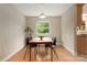 Dining area featuring hardwood floors, a modern light fixture, and a window with views of nature at 5604 Bethesda Ct, Charlotte, NC 28226