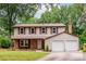Inviting two-story home featuring a brick accent, double garage, and manicured lawn at 5604 Bethesda Ct, Charlotte, NC 28226