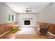 Bright Gathering room featuring hardwood floors, a painted brick fireplace, and comfortable seating at 5604 Bethesda Ct, Charlotte, NC 28226
