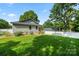The landscaped yard includes new fencing, mature trees, and a lush lawn at 6578 Bopre Ln, Denver, NC 28037
