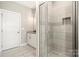 This bathroom has a walk-in shower with tiled walls, floors and a glass door at 6578 Bopre Ln, Denver, NC 28037