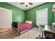 This bedroom has green walls, a bed with a plaid blanket, and a white chair at 6578 Bopre Ln, Denver, NC 28037