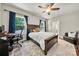 This bedroom has a wooden bed frame, a computer desk and a brown leather chair at 6578 Bopre Ln, Denver, NC 28037