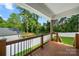 View from covered wood deck overlooking backyard, mature trees, and new fence at 6578 Bopre Ln, Denver, NC 28037