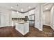 Bright kitchen with island, stainless steel appliances, granite countertops and white cabinetry at 6578 Bopre Ln, Denver, NC 28037