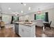 Bright, open kitchen with island and dining area featuring modern lighting at 6578 Bopre Ln, Denver, NC 28037