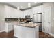 Bright kitchen with island, stainless steel appliances, granite countertops, and ample white cabinetry at 6578 Bopre Ln, Denver, NC 28037