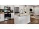 Kitchen island with stainless steel appliances, granite countertops, and white cabinets at 6578 Bopre Ln, Denver, NC 28037