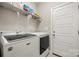 Bright laundry area features modern, front-loading machines and wire shelving for convenient storage at 6578 Bopre Ln, Denver, NC 28037