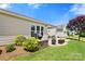 Backyard features stone patio with grill, and well-maintained landscaping at 7036 Kitty Hawk Ln, Fort Mill, SC 29707