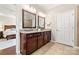Bathroom with granite countertops, dual sinks, wood cabinets, and a view into the bedroom and shower at 7036 Kitty Hawk Ln, Fort Mill, SC 29707